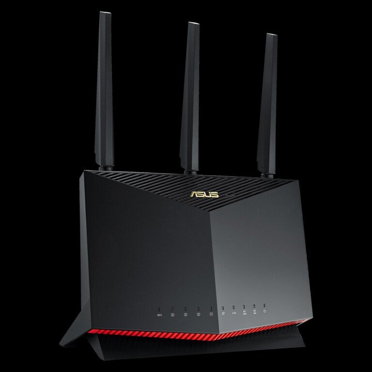Un router ASUS nero con dettagli dorati e LED rossi su sfondo nero.